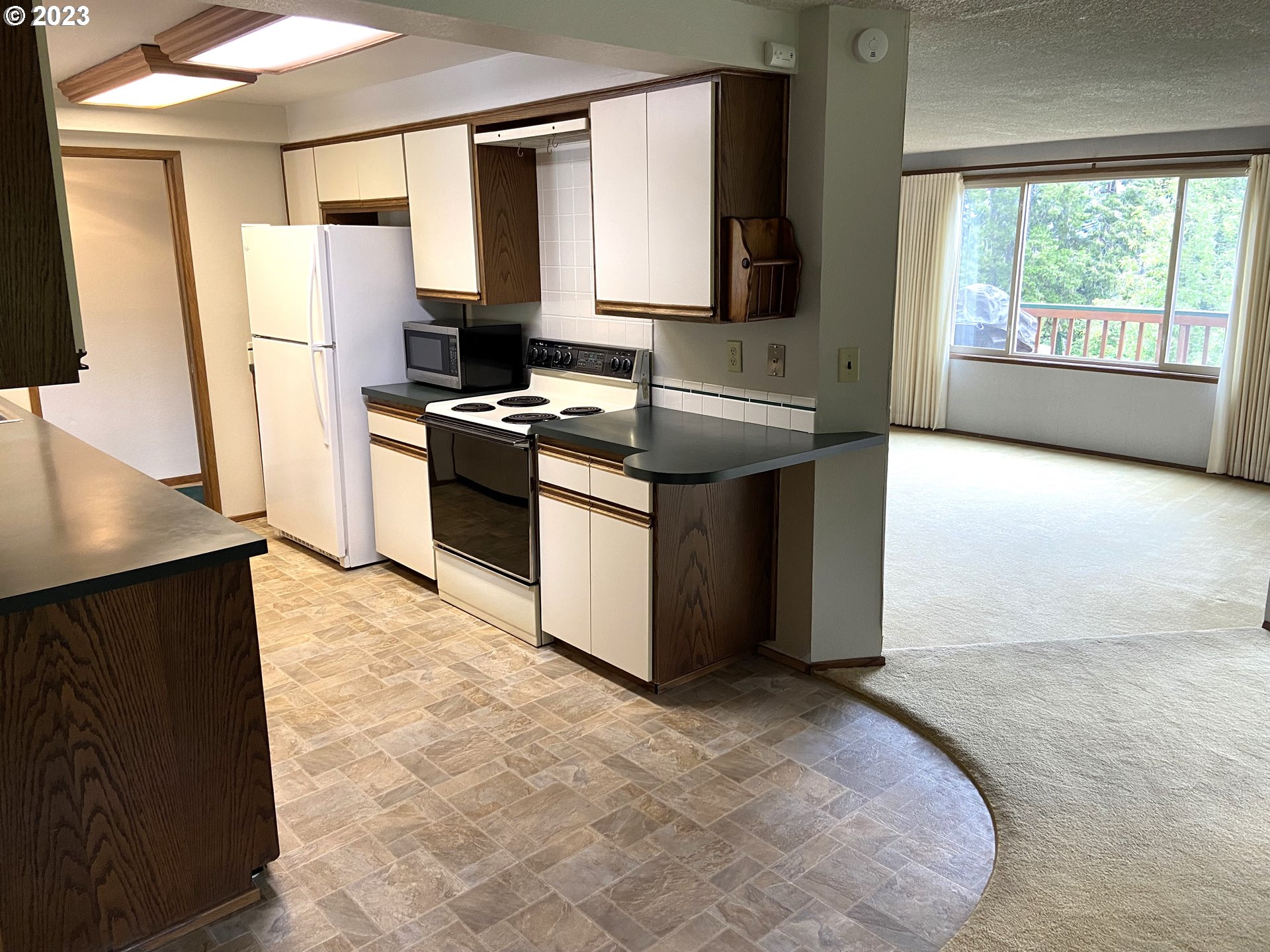 7905 South C Street Springfield, OR 97478 - Photo 9 of 28 a kitchen with stainless steel appliances granite countertop a stove a sink and a refrigerator