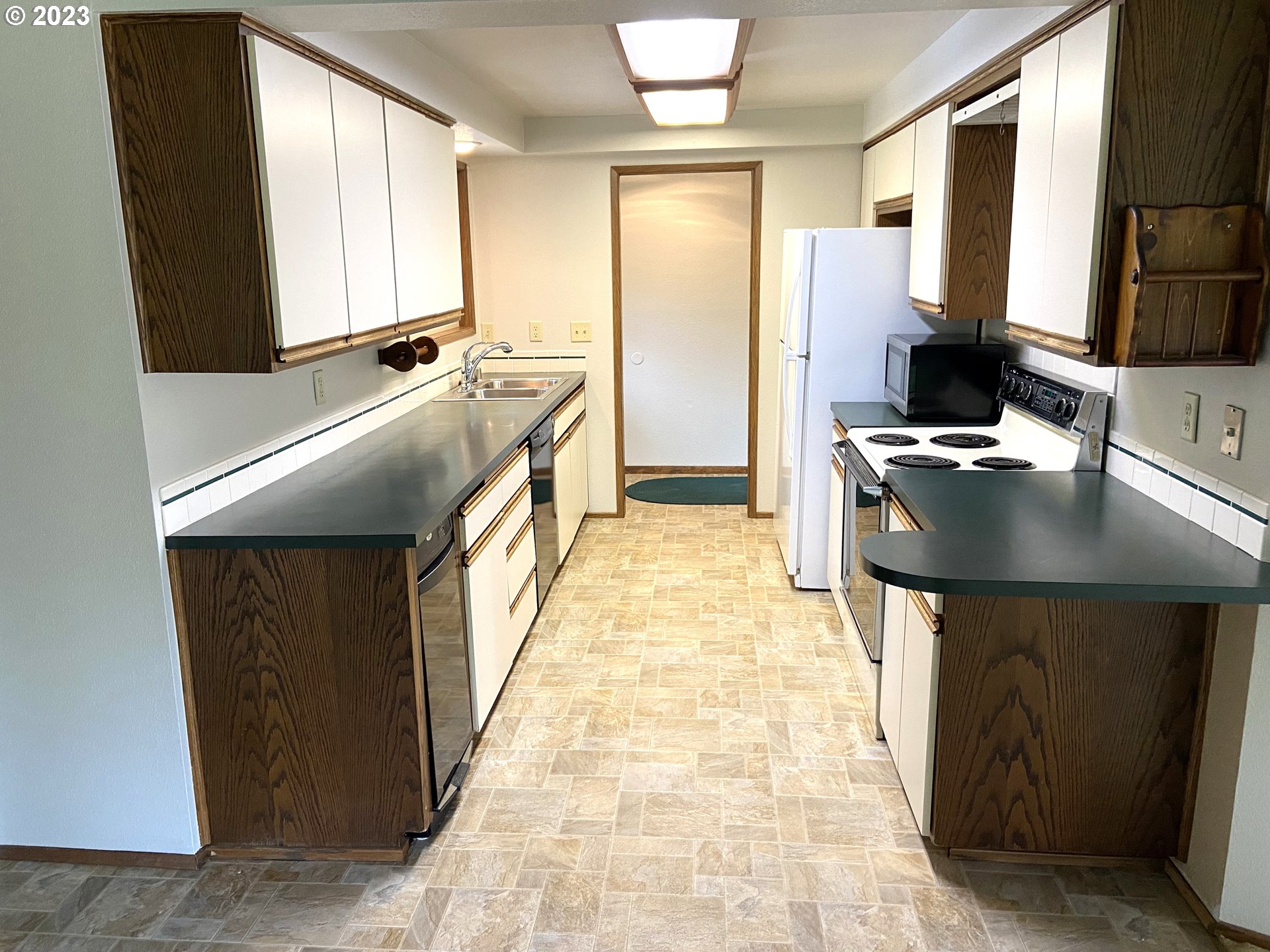 7905 South C Street Springfield, OR 97478 - Photo 10 of 28 a kitchen with stainless steel appliances granite countertop a refrigerator a stove and a sink