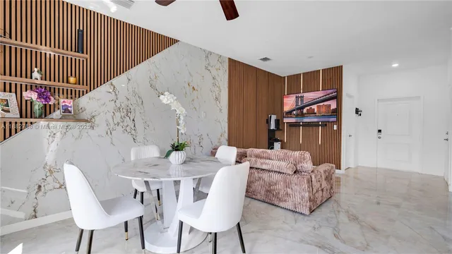 a dining room with furniture and wooden floor