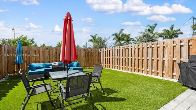 a view of a chairs and table in patio