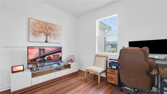 a work room with furniture and wooden floor