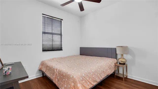 a bedroom with a bed and a night stand