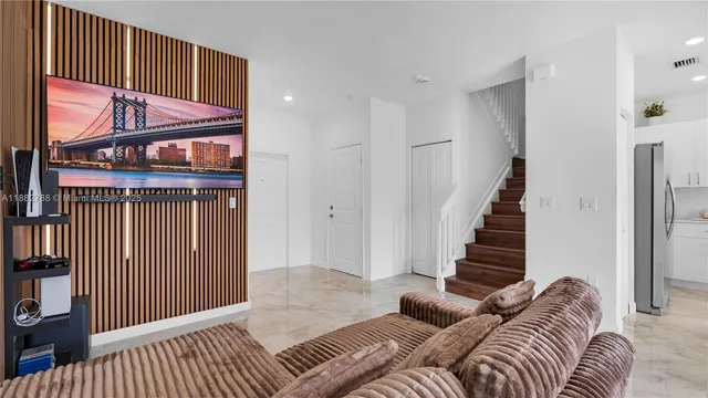 a view of a livingroom with furniture and stairs