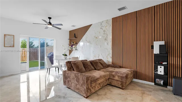a bedroom with a bed and glass door