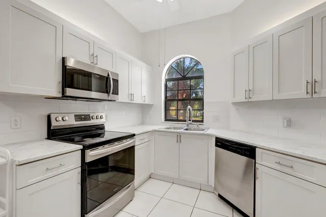 a bedroom with a bed and a view of kitchen