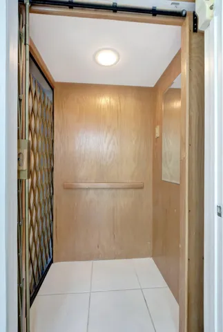 a living room with furniture large window and a flat screen tv