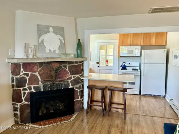 a room with wooden floors and fireplace