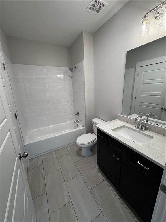 1777 Temple Avenue, Unit P Atlanta, GA 30337 - Photo 16 of 22 a spacious bathroom with a double vanity sink toilet mirror and a bathtub