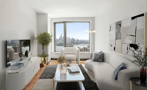 a living room with furniture lamp and a large window