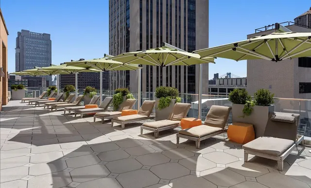 a view of a patio with a table and chairs under an umbrella