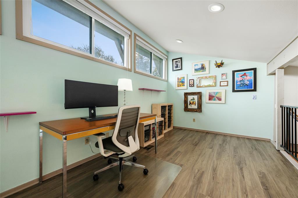 2210 Red Fox Road Austin, TX 78734 - Photo 34 of 40 This airy home office provides ample natural illumination and space for productivity, showcasing beautiful flooring.