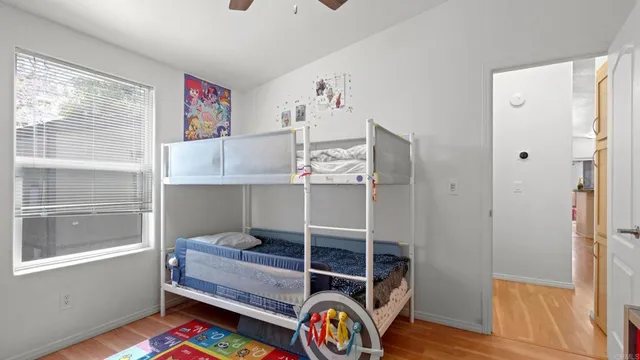 a bedroom with bunk bed and a window