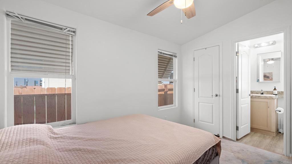 7495 Oakland Road, Unit 23 La Mesa, CA 91942 - Photo 17 of 24 a bedroom with a bed and a chandelier