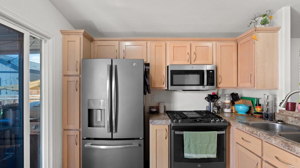 7495 Oakland Road, Unit 23 La Mesa, CA 91942 - Photo 2 of 24 a kitchen with stainless steel appliances granite countertop a refrigerator stove and sink