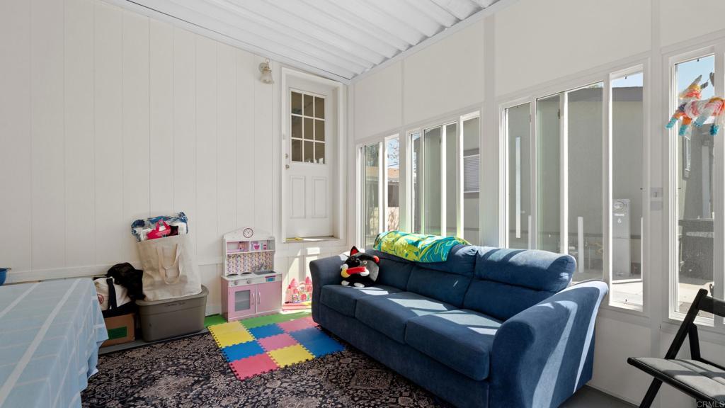 7495 Oakland Road, Unit 23 La Mesa, CA 91942 - Photo 21 of 24 a living room with furniture and a window