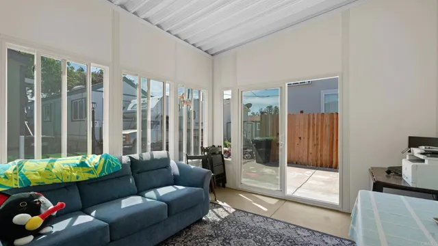 a living room with furniture and a floor to ceiling window