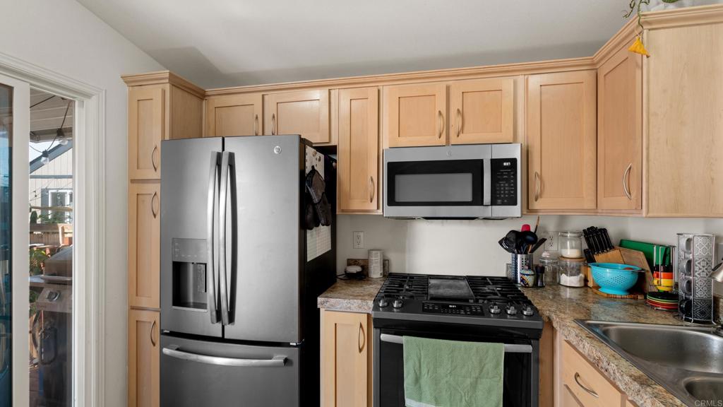 7495 Oakland Road, Unit 23 La Mesa, CA 91942 - Photo 4 of 24 a kitchen with a refrigerator sink and microwave
