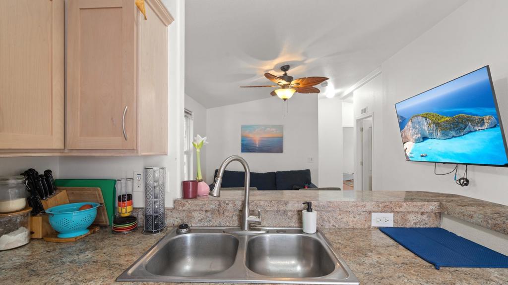 7495 Oakland Road, Unit 23 La Mesa, CA 91942 - Photo 5 of 24 a kitchen with a sink and a couch