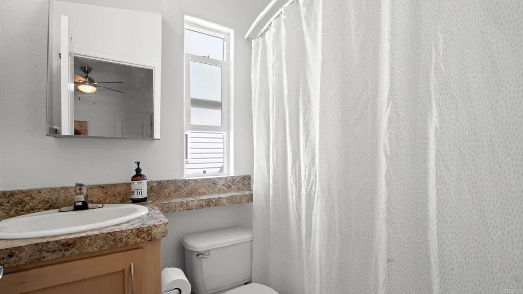 7495 Oakland Road, Unit 23 La Mesa, CA 91942 - Photo 8 of 24 a bathroom with a granite countertop sink and a mirror