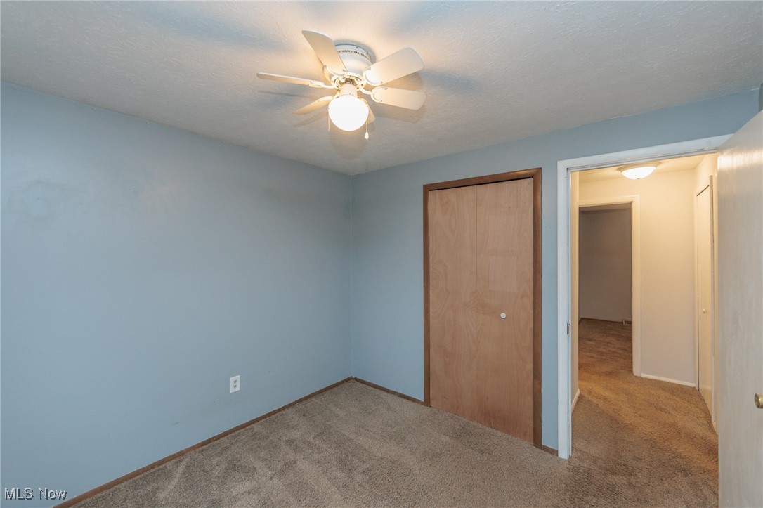 28013 Knickerbocker Road Bay Village, OH 44140 - Photo 19 of 38 Second floor bedroom featuring carpet, a closet, ceiling fan, and a textured ceiling