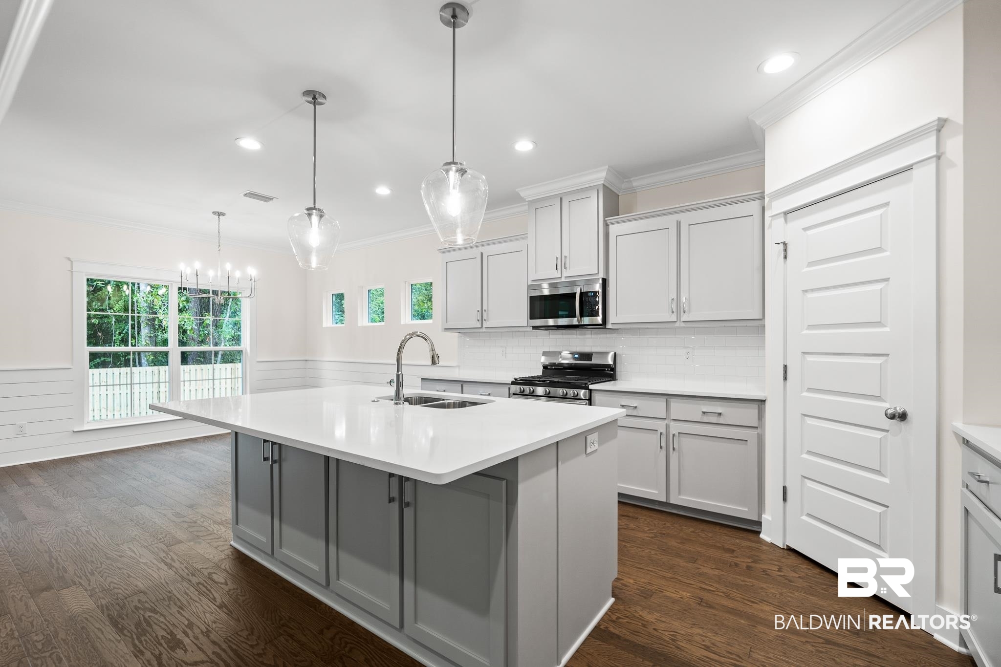 29 Signal Hill Road Daphne, AL 36527 - Photo 11 of 36 Kitchen with decorative light fixtures, stainless steel appliances, dark hardwood / wood-style flooring, sink, and an island with sink
