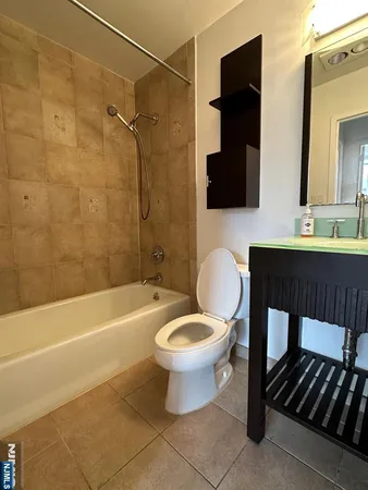 a bathroom with a toilet a sink and bathtub