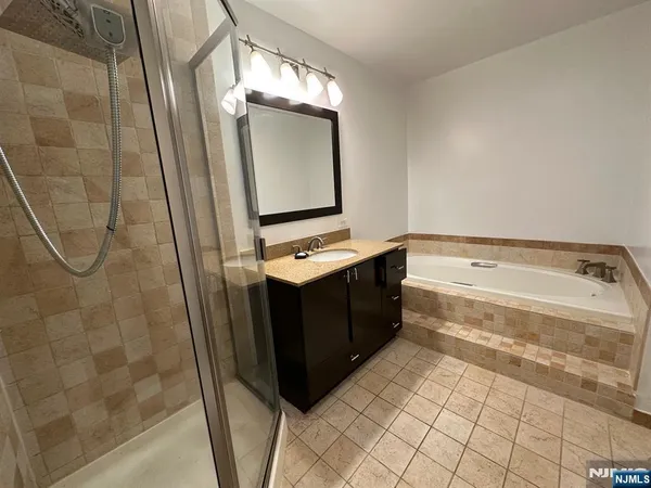 a bathroom with a bathtub and a mirror