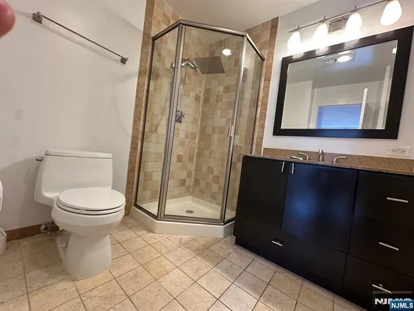 a bathroom with a toilet a sink and shower