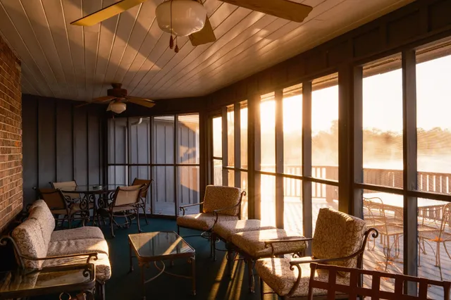 a room with pool table and windows