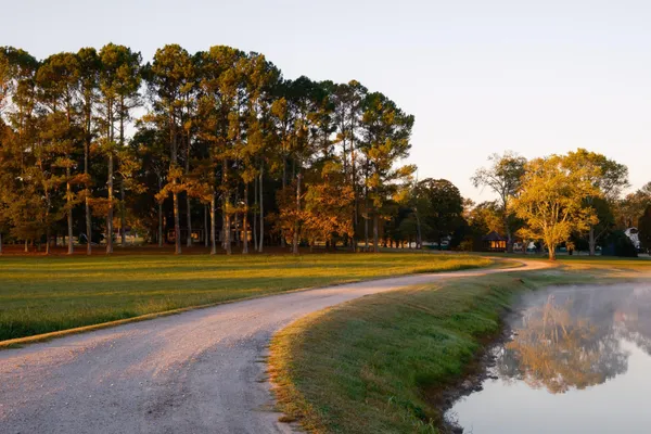 an aerial view of a house with swimming pool and porch