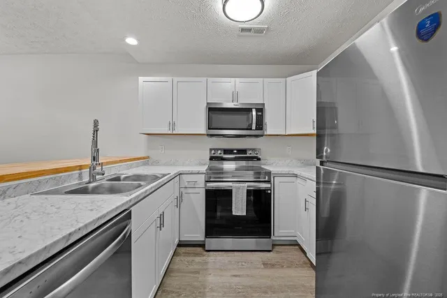 a kitchen with a sink stove and refrigerator