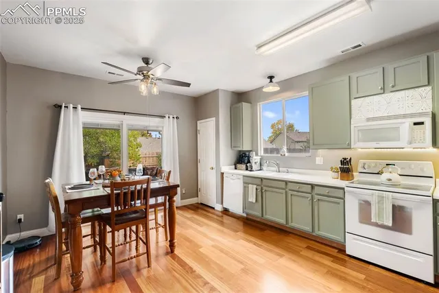a kitchen with a sink a window and cabinets