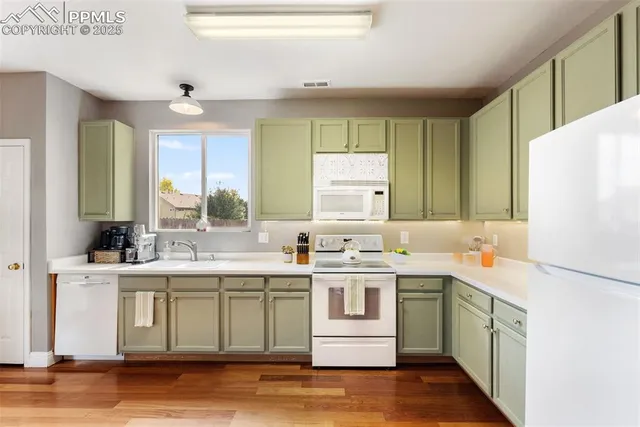 a view of a a dining room with furniture window and wooden floor