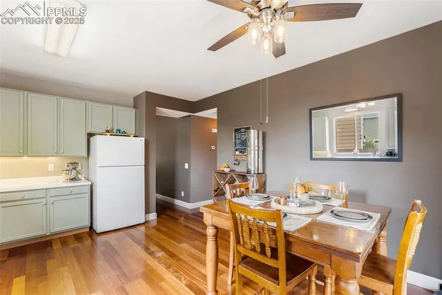 a dining room with furniture a chandelier and wooden floor