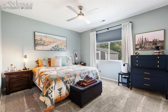 a bedroom with a bed and a painting on the wall