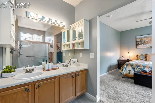 a bedroom with a bed and a refrigerator