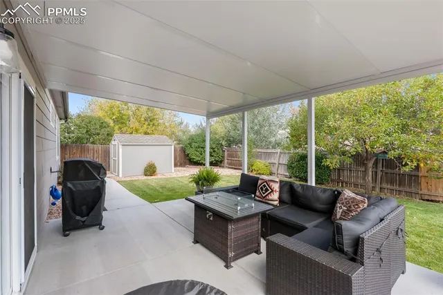 a view of a house with backyard and sitting area