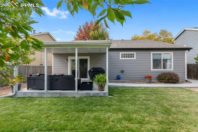 a view of a house with a yard and sitting area