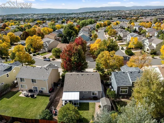 an aerial view of a house with a big yard
