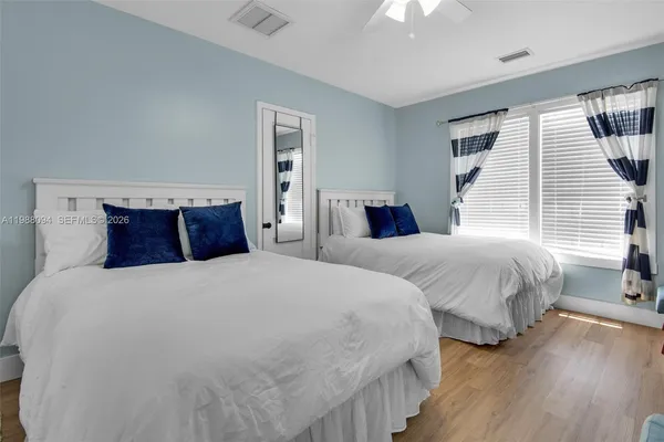 a bedroom with two beds and a chandelier
