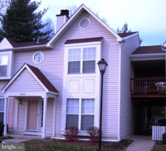 7808 Harrowgate Circle, Unit C Springfield, VA 22152 - Photo 1 of 12 a front view of a house with glass windows