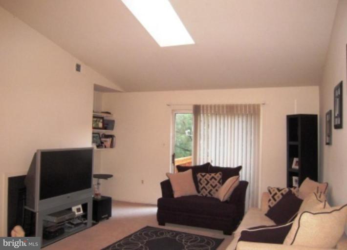 7808 Harrowgate Circle, Unit C Springfield, VA 22152 - Photo 12 of 12 a living room with furniture and a flat screen tv