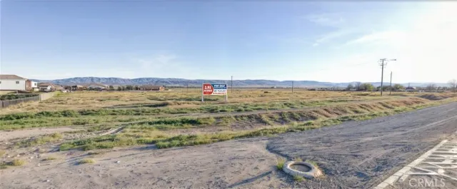 a view of a field with an ocean