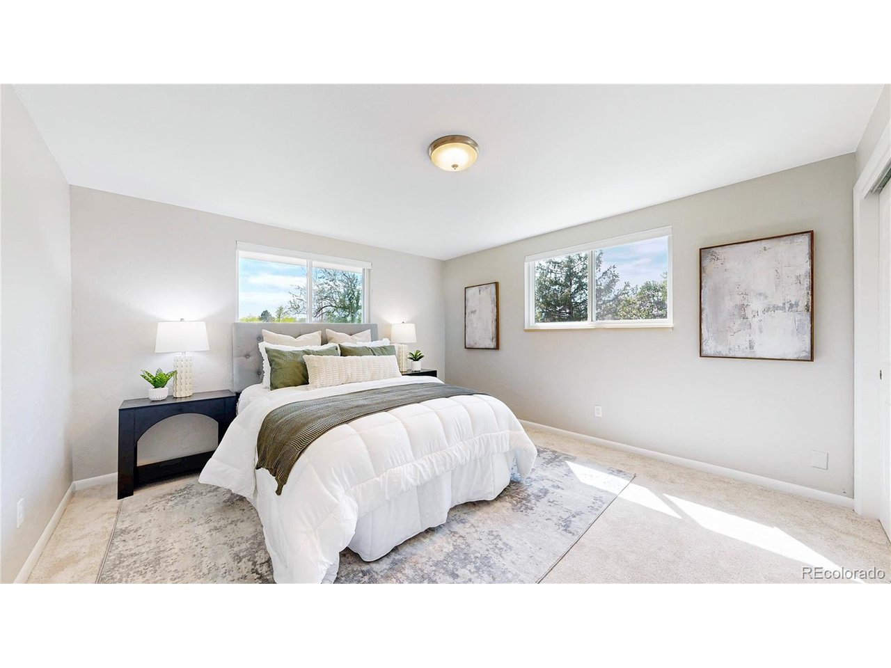 9395 West 45th Avenue Wheat Ridge, CO 80033 - Photo 18 of 48 a bed room with a bed a painting and lamp