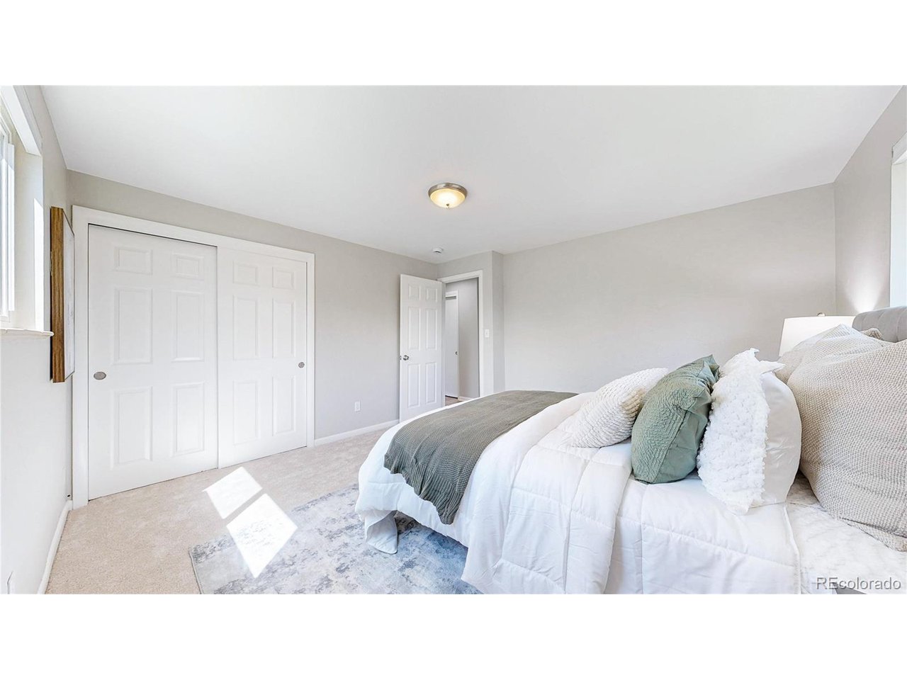 9395 West 45th Avenue Wheat Ridge, CO 80033 - Photo 20 of 48 a bedroom with a bed and a night stand