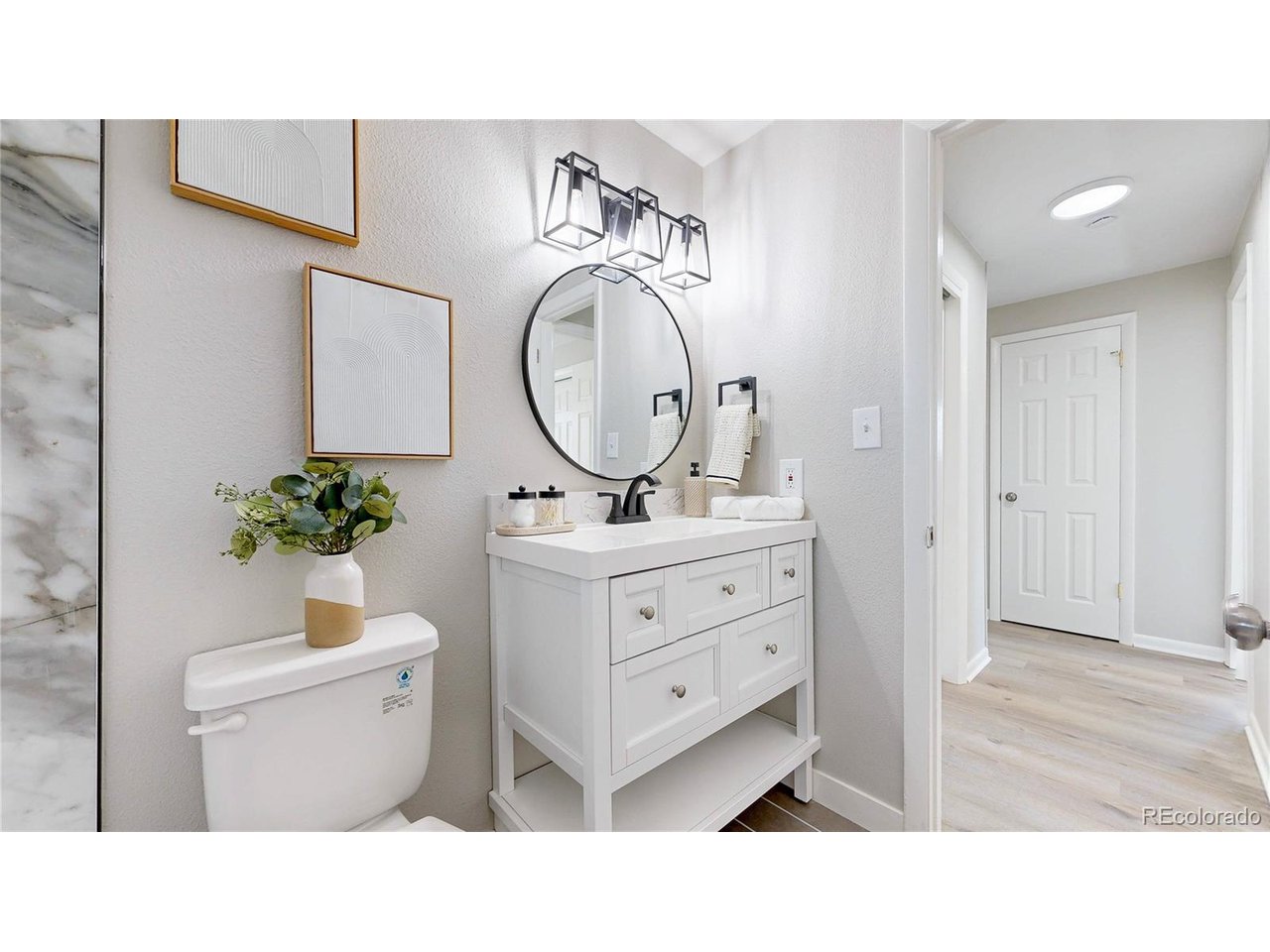 9395 West 45th Avenue Wheat Ridge, CO 80033 - Photo 25 of 48 a bathroom with a sink double vanity and a mirror