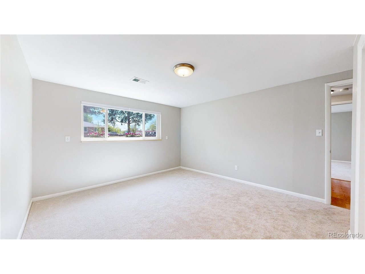 9395 West 45th Avenue Wheat Ridge, CO 80033 - Photo 36 of 48 a open hall with a bench