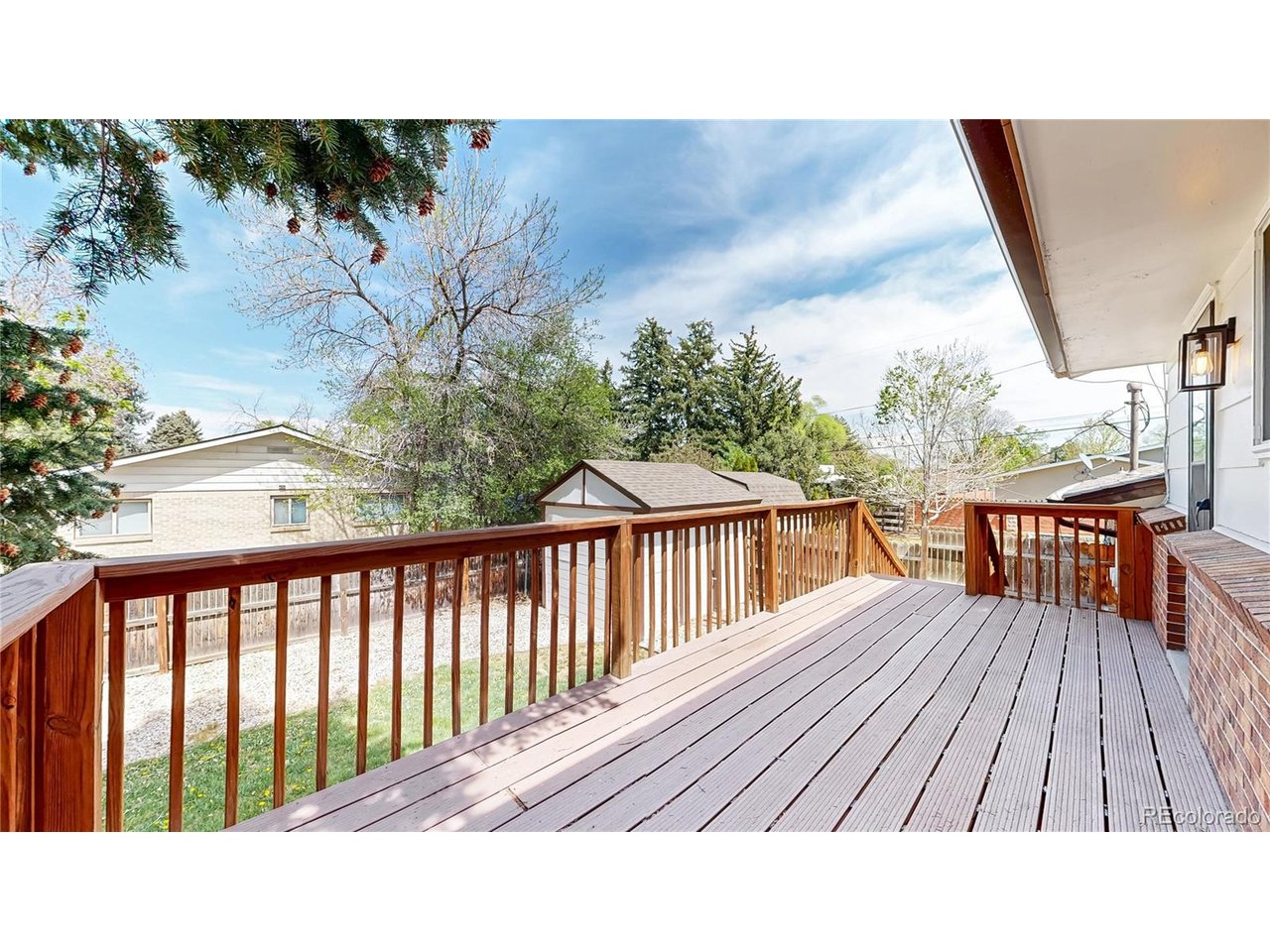 9395 West 45th Avenue Wheat Ridge, CO 80033 - Photo 38 of 48 a balcony with wooden floor and fence