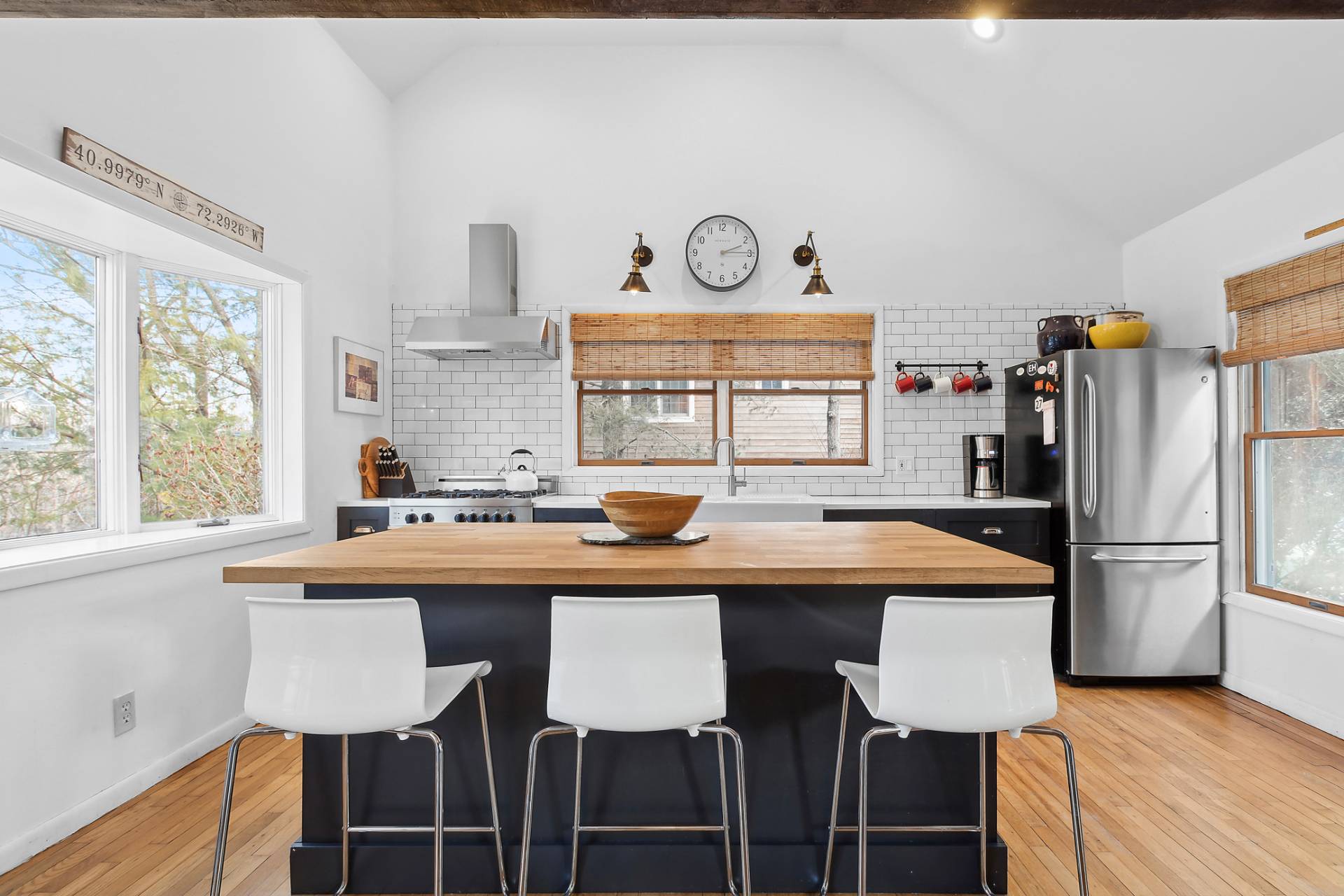 a kitchen with stainless steel appliances granite countertop a sink and a refrigerator