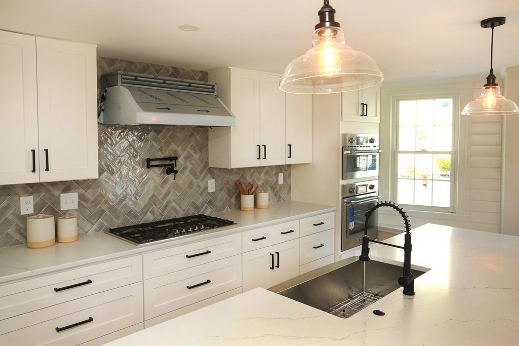 a kitchen with a cabinets and chandelier